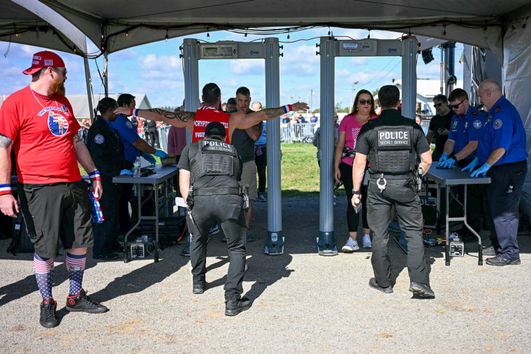 Attendees go through security.