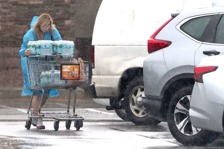 A shopper stocks up on water