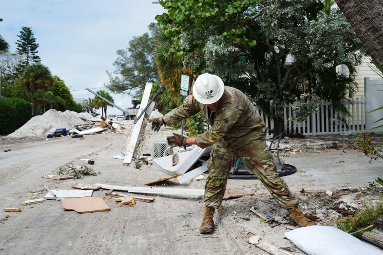 A Florida Army National Guard member removes debris in St. Petersburg