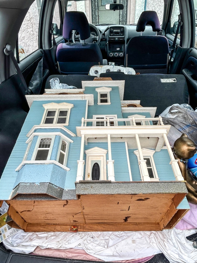 The blue and white dollhouse Rhonda Keigher built 10 years ago in the trunk of her car.