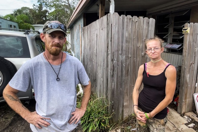 Jesse Hancock and Ria Blaight tried to salvage what they could Tuesday from their flooded home in the Twin City mobile home park.