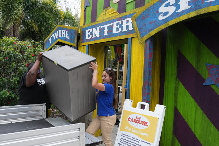 The zoo has several hurricane-proof buildings where it plans to move all of its animals in the next few hours. "We hope they suffer as little stress as possible, that's always our goal," Burns explains. In a small enclosure, two zookeepers lure a porcupine into a cage by feeding it pieces of carrot and strawberry. Once the animal is enclosed, they carefully lift it into a golf cart and take it under cover.