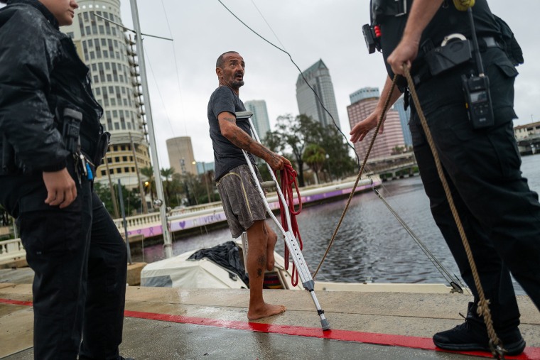 Tampa police try to coax a man living on his boat "Lieutenant Dan" go for his safety