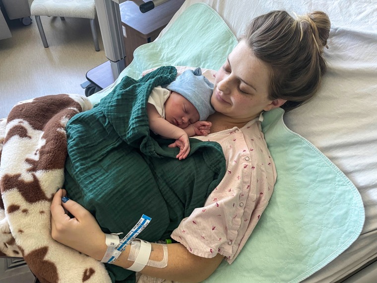 Kenzie Lewellen holding her son, Dewey Lester Bennett, IV.