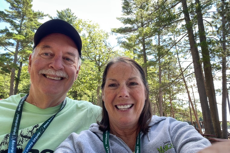 Chuck, left, and Sharon Zimmer take a selfie outside by the trees