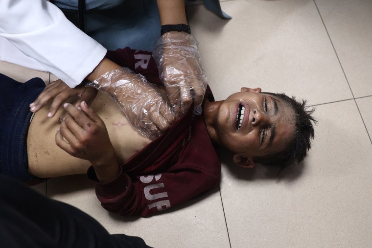 An injured Palestinian boy receives medical attention at al Aqsa Martyrs hospital after an Israeli strike hit a school housing displaced people in Deir al-Balah in the central Gaza Strip, on Oct. 10, 2024.