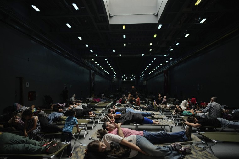 Evacuees rest on a Turkish military ship in Beirut