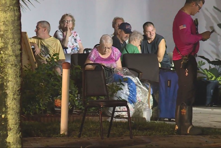 Residents at Spanish Lakes Country Club Village in St. Lucie County, Fla., early on Oct. 10, 2024, after a tornado tore through the area.