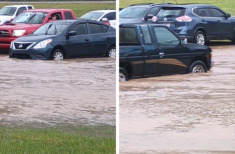 Zinnia Adkins takes multiple photos showing water beginning to rise against tires of cars in the parking lot. 