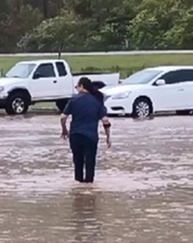 Bertha Mendoza walking across the parking lot.