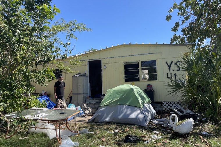 James William Lawson Jr. stands near his damaged home.