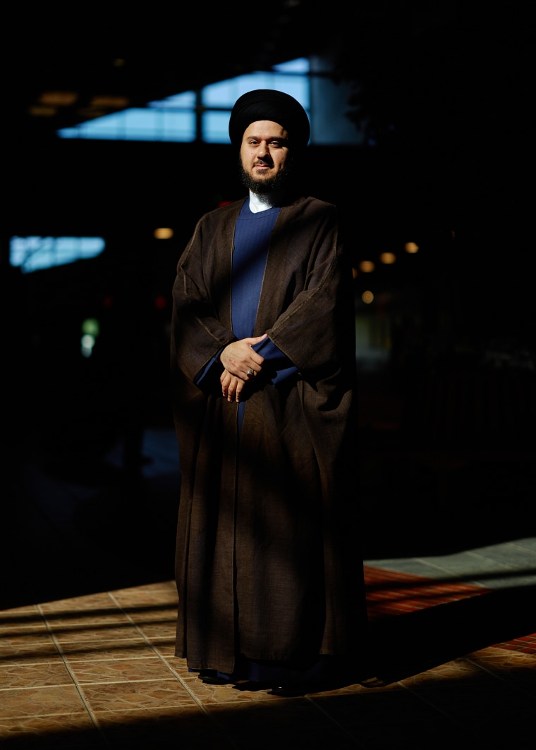 Imam Syed Saleh Qazwini stands at the portrait