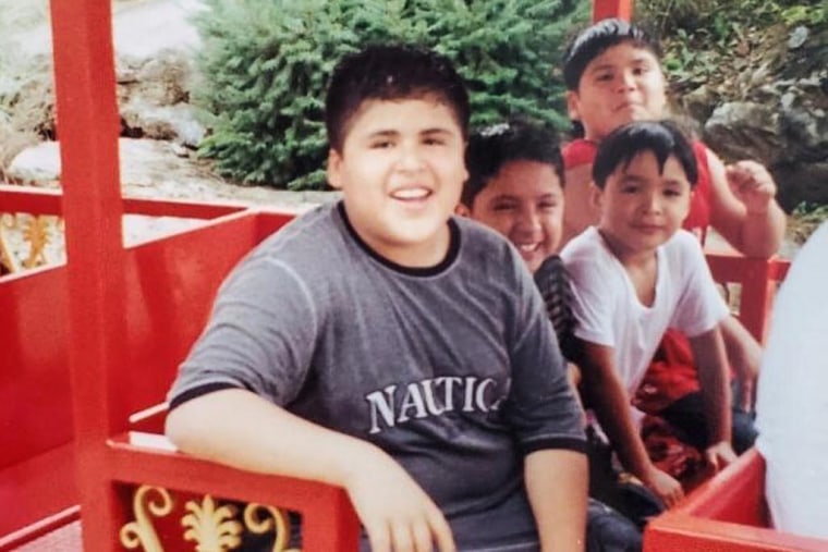 A young Jonathan Perez, center, with his brother and cousins ​​at a theme park