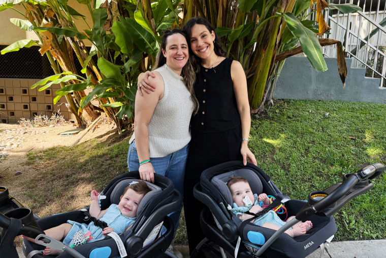 Ashley Louise and Claire Wasserman pose for a photo with their twins Antonia and Raphael.