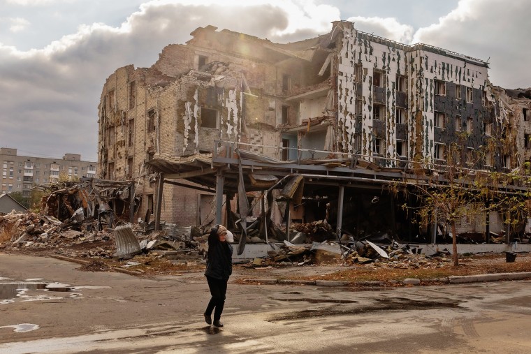 A woman walks past a building damaged by shelling in Pokrovsk, the eastern Donetsk region, on Oct.15, 2024.