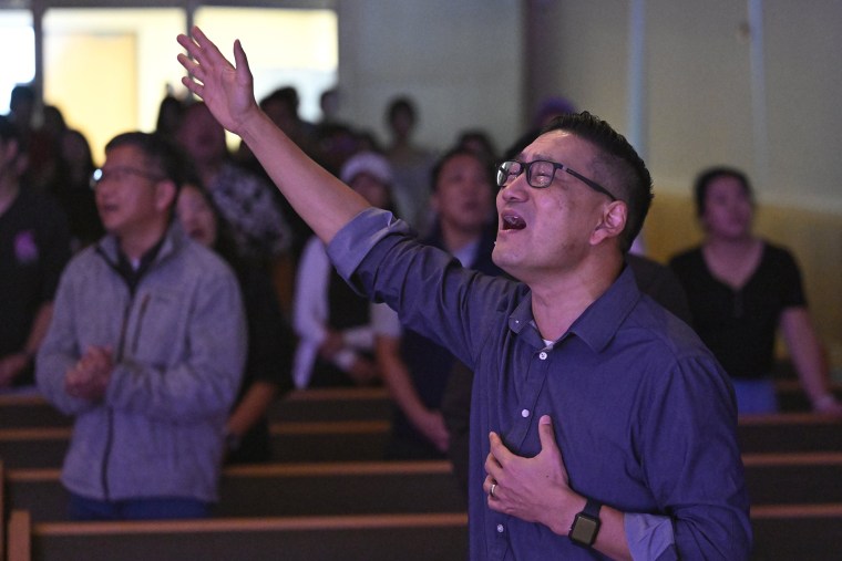 Pastor Owen Lee sings during a service