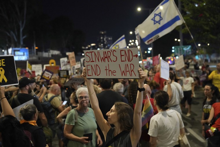 A demonstrator holds a sign about the killing of Hamas leader Yahya Sinwar during a protest calling for a cease-fire deal and the immediate release of hostages held by Hamas on Thursday, Oct. 17, 2024, in Tel Aviv, Israel. 