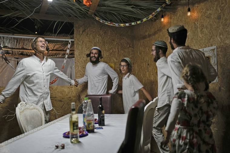 Israelis celebrate near Kibbutz Erez, southern Israel, on Thursday, Oct. 17, 2024.