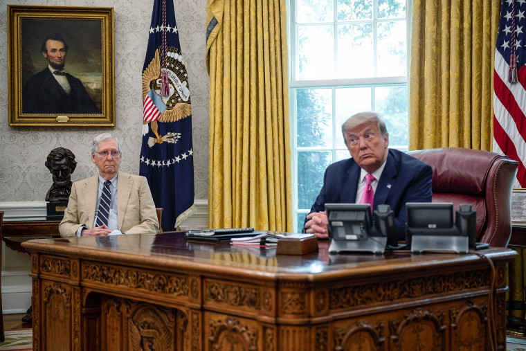 Then-President Donald Trump speaks with Sen. Mitch McConnell, 