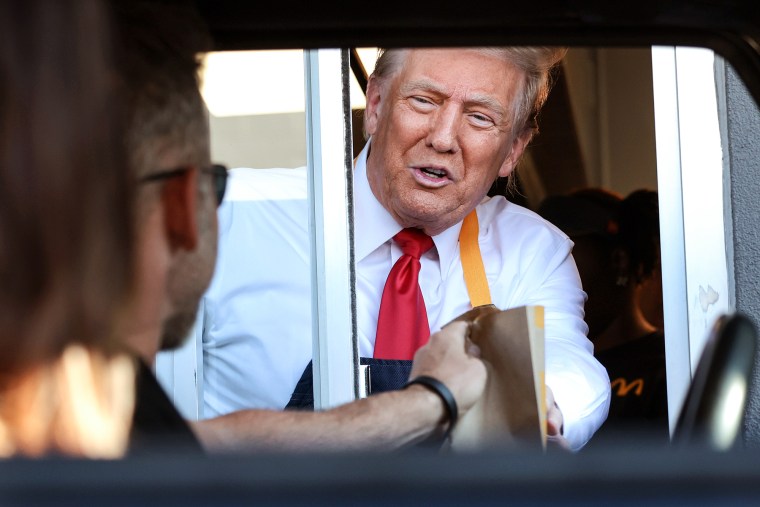 Donald Trump works the drive-through line while visiting a McDonald's restaurant