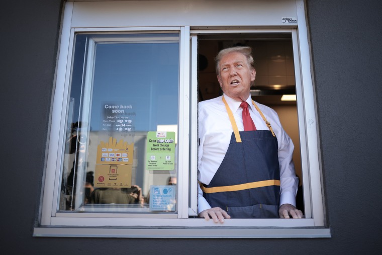 Former President Donald Trump works the drive-thru at a McDonald's.