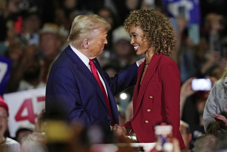 Former President Donald Trump greets moderator Sage Steele