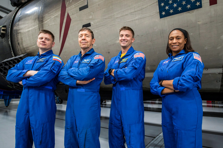 The four crew members that comprise the SpaceX Crew-8 mission pose for a photo inside SpaceX Hangar X at the Kennedy Space Center