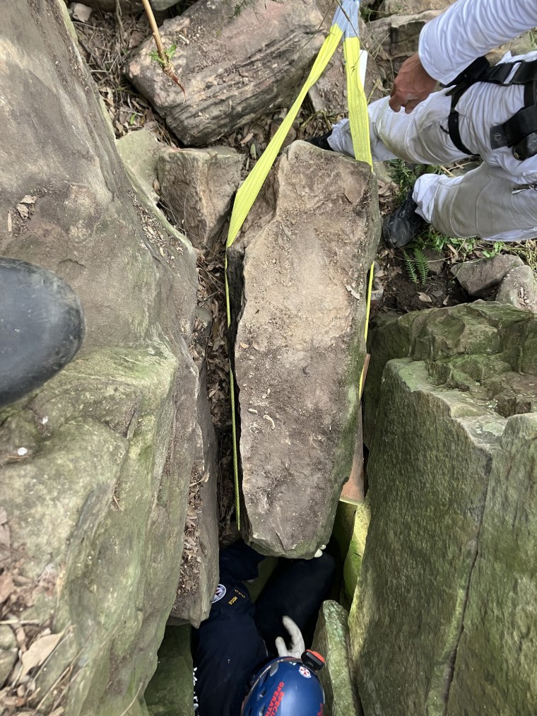 In Australia, a woman was rescued after being pressed upside down between boulders for seven hours.