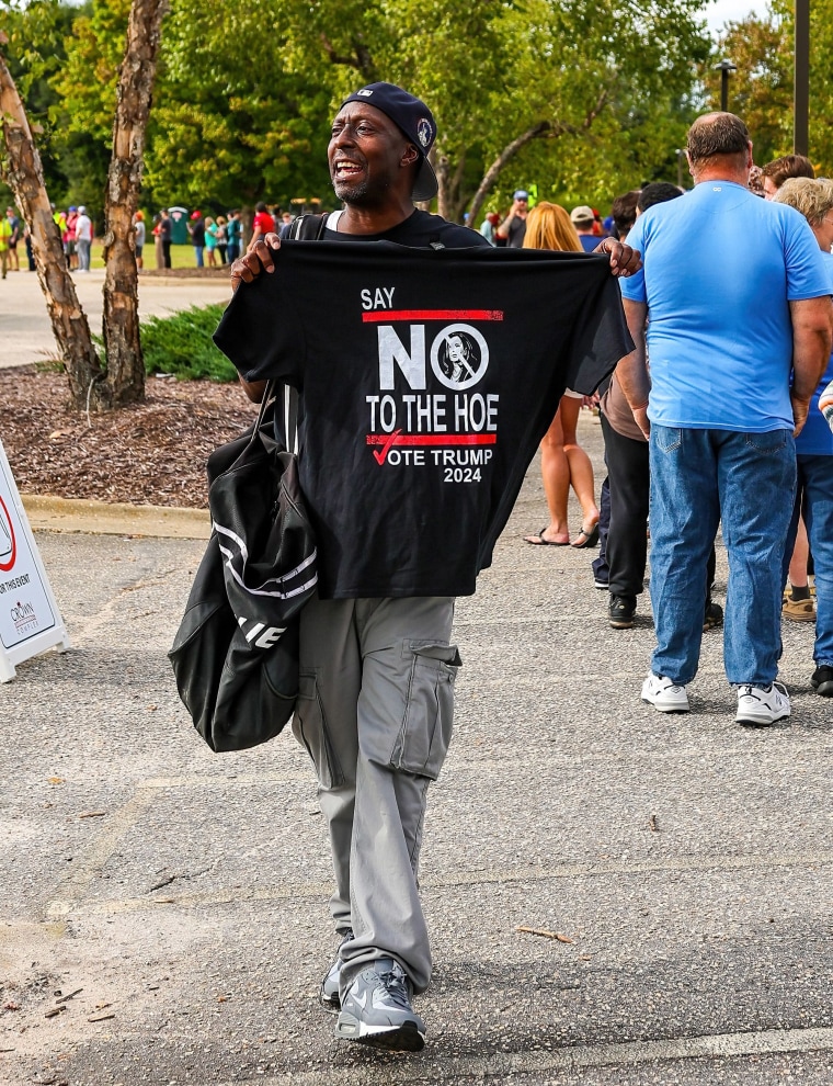 A vendor sells a derogatory shirt prior at a Trump event