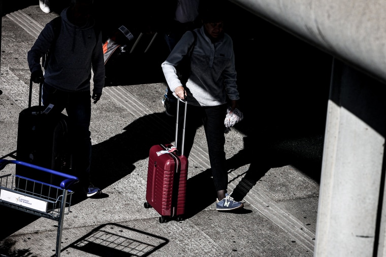 Travelers with suitcases.