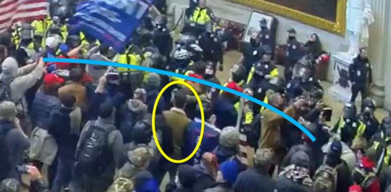 Zachary Pearlman faces off with a line of police officers at the Capitol on Jan. 6, 2021.