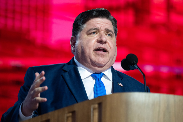 JB Pritzker speaks behind a podium