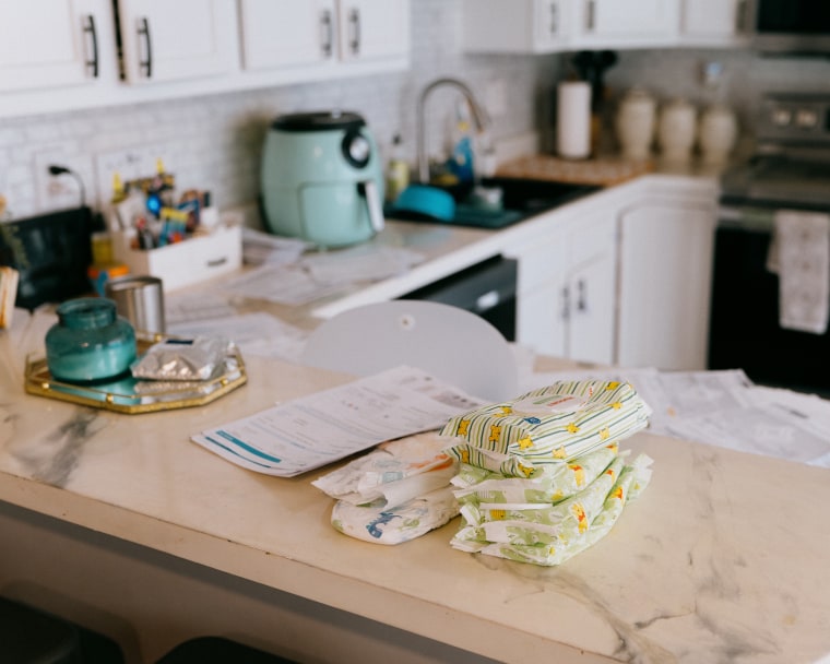 Bills, diapers and wipes lie on the counter at the Hurley home.