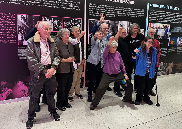 Members of the Gay Liberation Front and Radicalesbians pose for a reunion photo at the Stonewall National Monument Visitor Center in New York