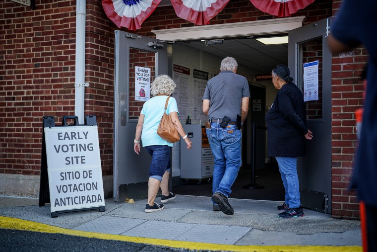 People enter early voting place.