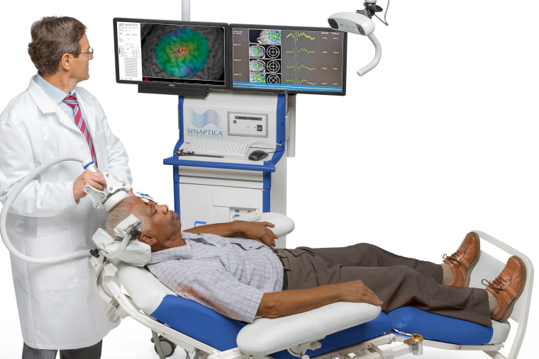 A doctor uses the TMS device on a patient