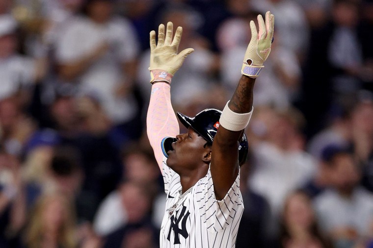 Jazz Chisholm Jr. celebrates with his arms in the air 