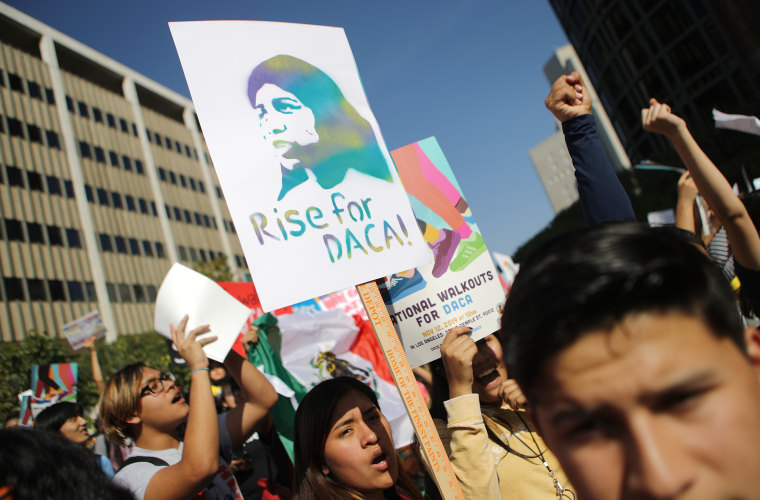 Protesters hold signs as they rally