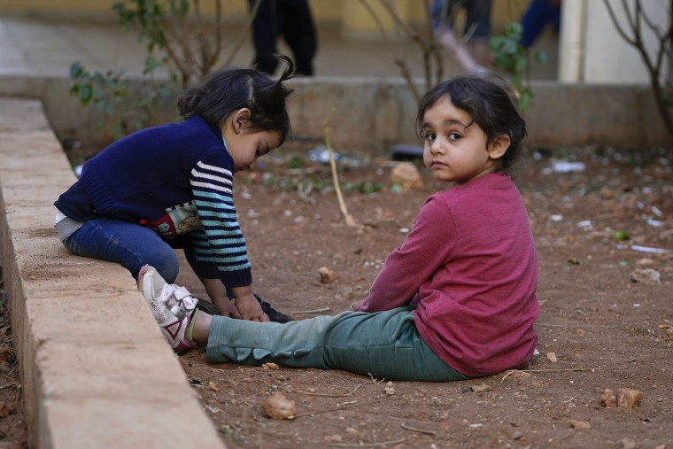 Displaced children play at a school being used as a shelter