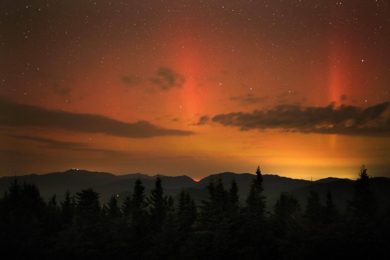 The Northern Lights color the sky over the White Mountains just after midnight on Friday, September 13, 2024. View from the top of a mountain in Chatham, New Hampshire.