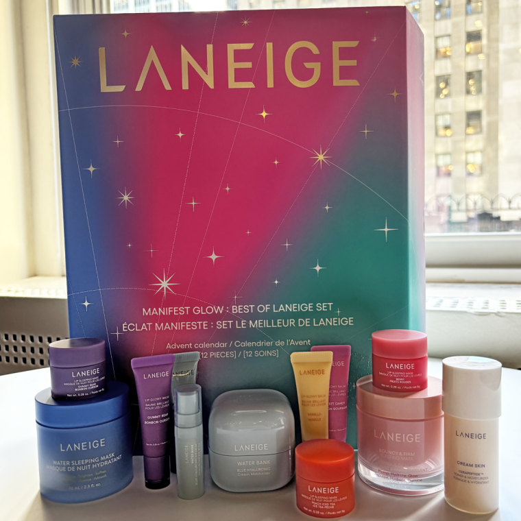 The Laneige Advent calendar standing up on a table with a handful of the brand’s products in front of it.