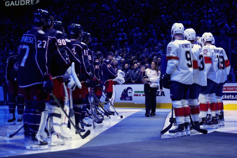 Meredith Gaudreau steps onto the ice during a memorial service for her husband, Columbus Blue Jackets player Johnny Gaudreau, before the home game against the Florida Panthers at Nationwide Arena on October 15, 2024 in Columbus, Ohio. 