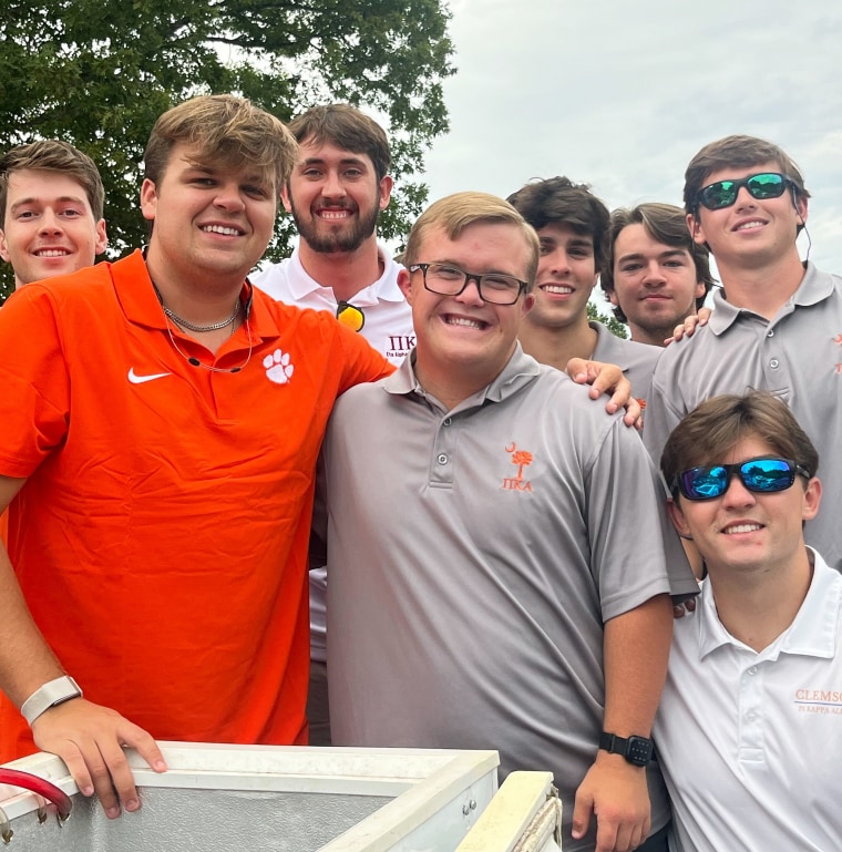 Charlie McGee posed for photos with his fraternity brothers, including PIKE Treasurer Zach Freeman (in orange shirt).