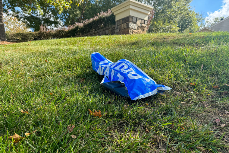 A crumpled Harris sign in the yard.