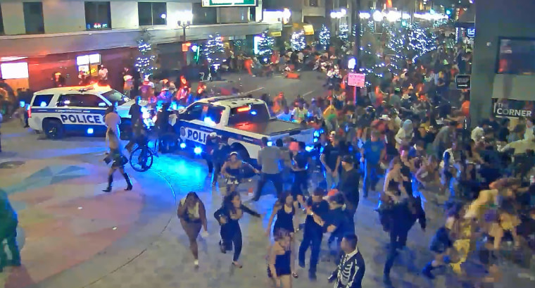 People flee after a shooting in downtown Orlando, Fla., early on Nov. 1, 2024.