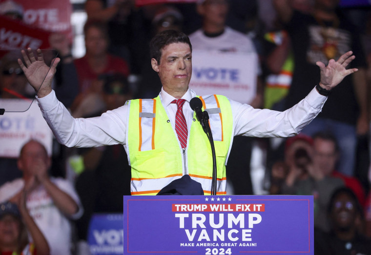 Republican Senate candidate Sam Brown wears a reflective vest at a Trump rally