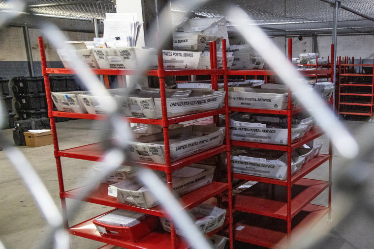 Image: Mail-in ballots are secured inside a cage before Election Day