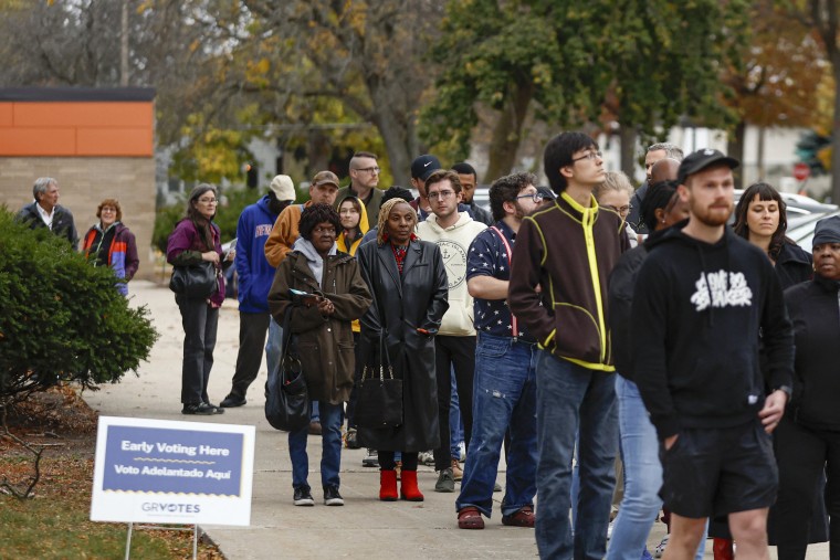 Voters wait in line to to cast early ballots at Ottawa Hills High School in Grand Rapids, Mich., on Nov. 3, 2024.