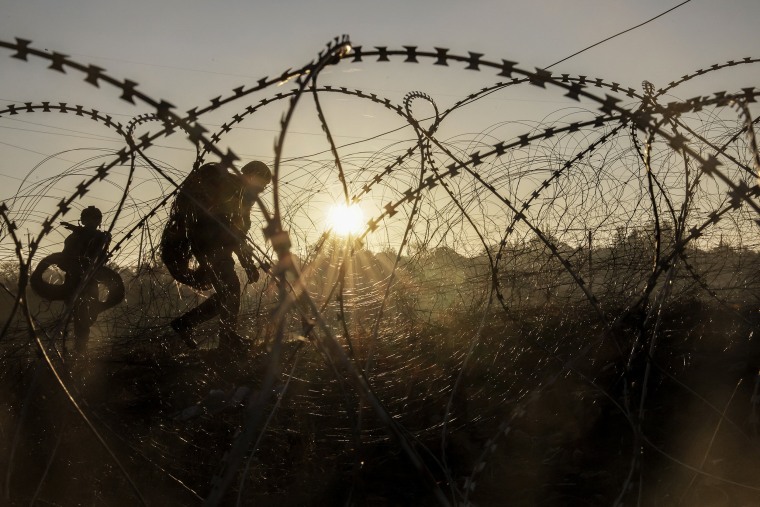 Ukrainian soldiers installing razor wire along the frontline in the Donetsk region