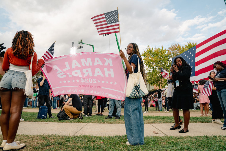 Harris supporters hold a flag before her speech at Howard University on Wednesday.